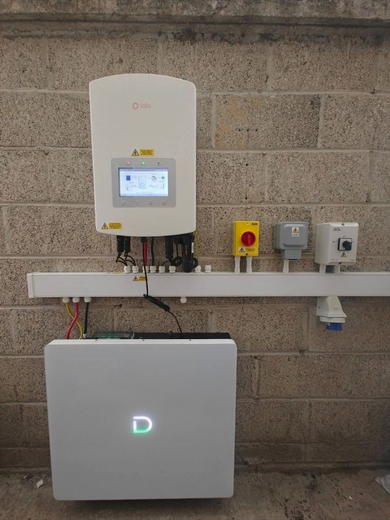 Solis solar inverter and home battery installed by Maher Electrical on a block wall in Co. Laois